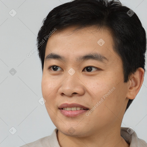 Joyful asian young-adult male with short  black hair and brown eyes