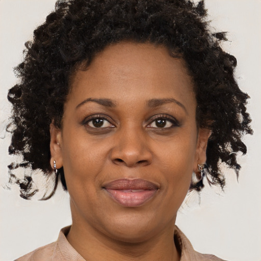 Joyful black adult female with short  brown hair and brown eyes