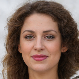 Joyful white adult female with long  brown hair and brown eyes