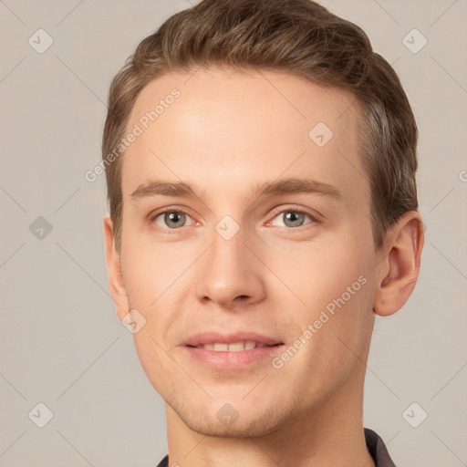 Joyful white young-adult male with short  brown hair and grey eyes