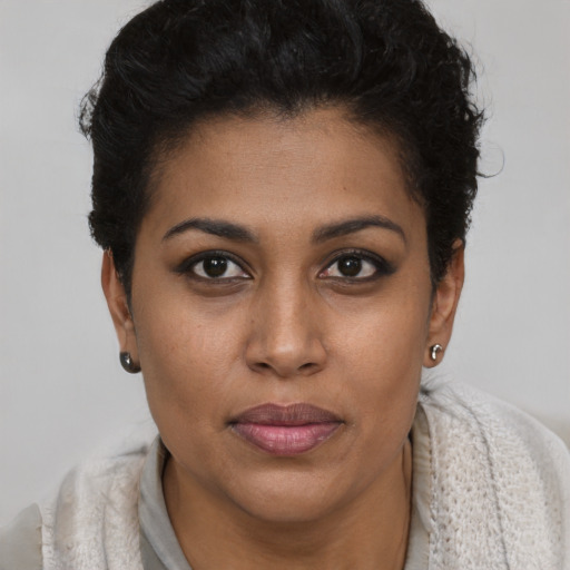 Joyful black young-adult female with short  brown hair and brown eyes
