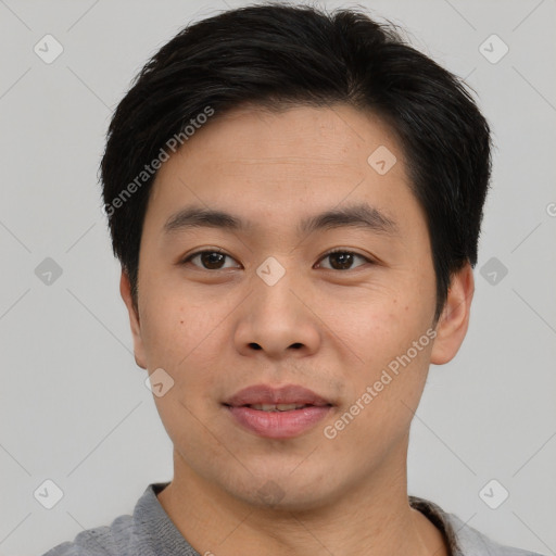 Joyful asian young-adult male with short  brown hair and brown eyes