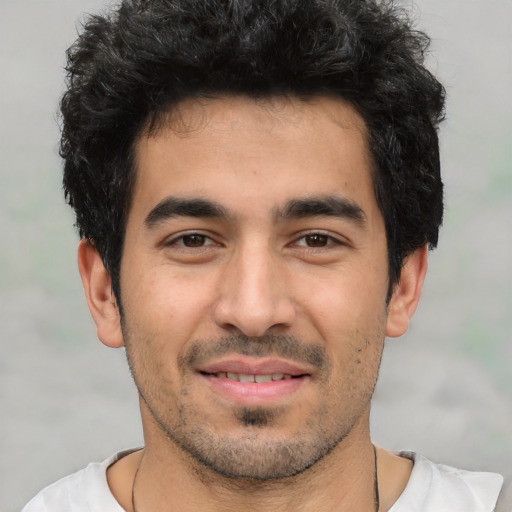 Joyful white young-adult male with short  black hair and brown eyes