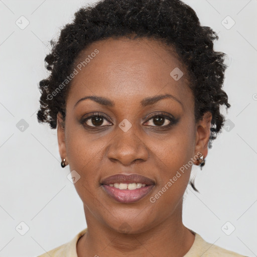 Joyful black adult female with short  brown hair and brown eyes