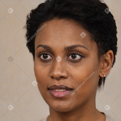 Joyful black young-adult female with short  black hair and brown eyes