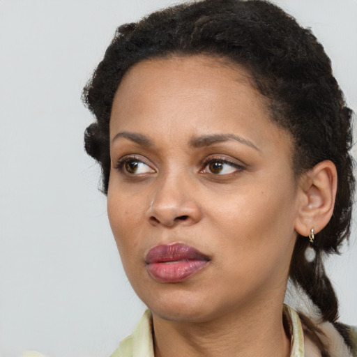 Joyful black young-adult female with medium  black hair and brown eyes