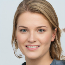 Joyful white young-adult female with medium  brown hair and blue eyes