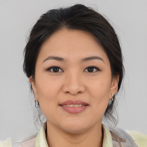 Joyful asian young-adult female with medium  brown hair and brown eyes