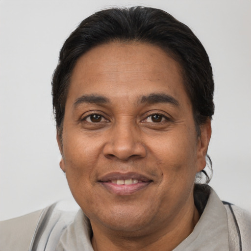Joyful latino adult male with short  brown hair and brown eyes