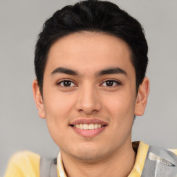 Joyful asian young-adult male with short  brown hair and brown eyes