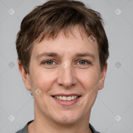 Joyful white adult male with short  brown hair and grey eyes