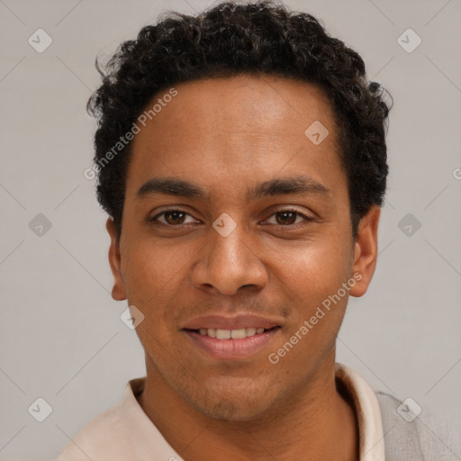 Joyful black young-adult male with short  brown hair and brown eyes