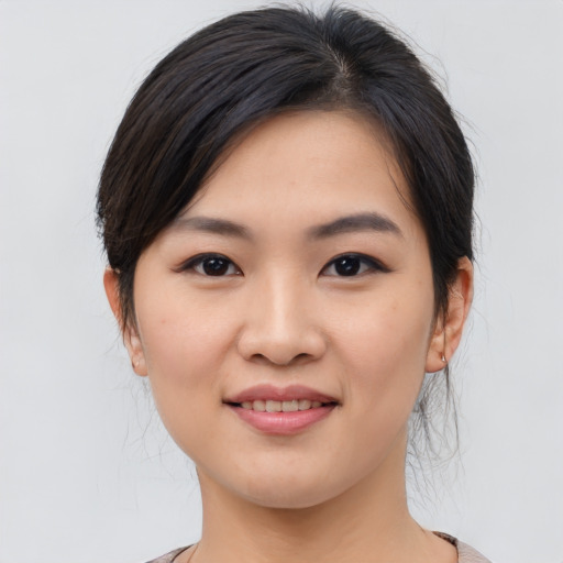 Joyful asian young-adult female with medium  brown hair and brown eyes