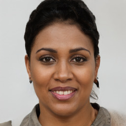 Joyful latino young-adult female with short  brown hair and brown eyes