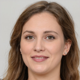 Joyful white young-adult female with long  brown hair and green eyes