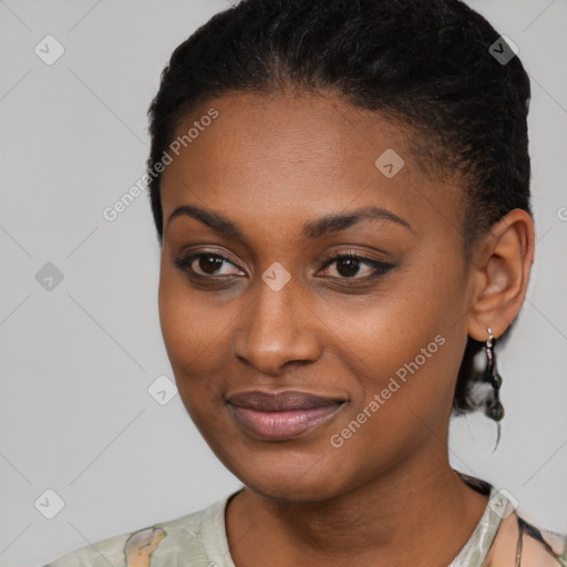 Joyful black young-adult female with short  black hair and brown eyes