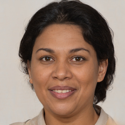 Joyful white adult female with medium  brown hair and brown eyes