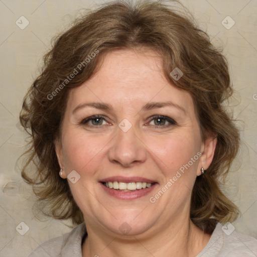 Joyful white adult female with medium  brown hair and green eyes