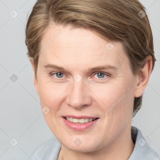 Joyful white adult female with short  brown hair and grey eyes