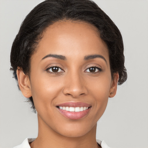 Joyful latino young-adult female with medium  brown hair and brown eyes