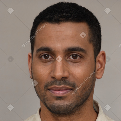 Joyful black young-adult male with short  black hair and brown eyes