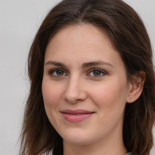 Joyful white young-adult female with long  brown hair and brown eyes