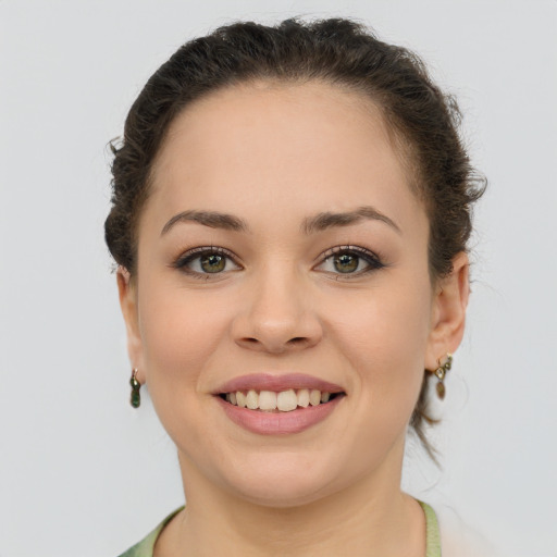 Joyful white young-adult female with medium  brown hair and green eyes
