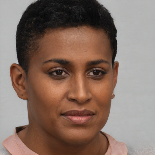 Joyful black young-adult female with short  brown hair and brown eyes