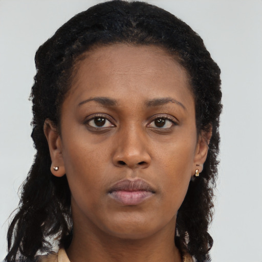 Neutral black young-adult female with long  brown hair and brown eyes