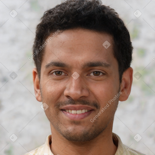 Joyful black young-adult male with short  brown hair and brown eyes