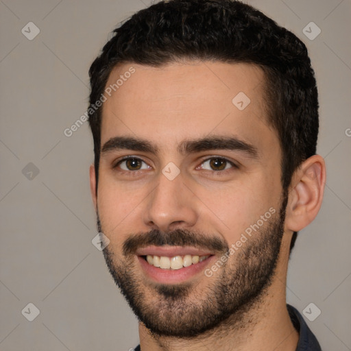 Joyful white young-adult male with short  black hair and brown eyes