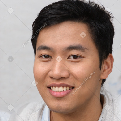 Joyful asian young-adult male with short  brown hair and brown eyes