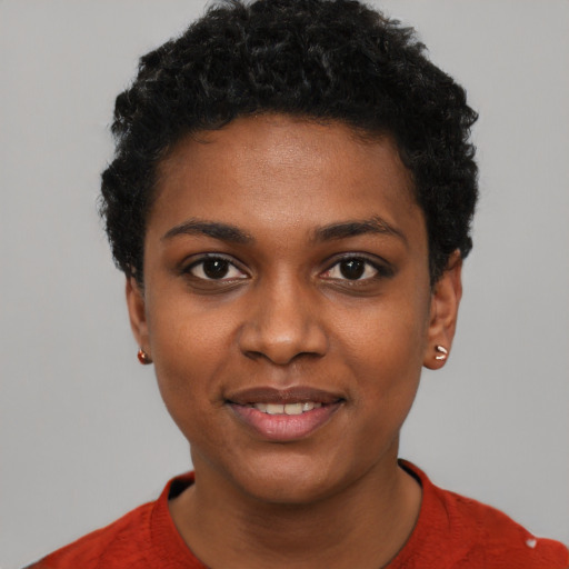 Joyful black young-adult female with short  black hair and brown eyes