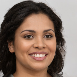 Joyful latino young-adult female with long  brown hair and brown eyes