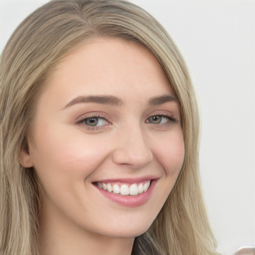 Joyful white young-adult female with long  brown hair and green eyes