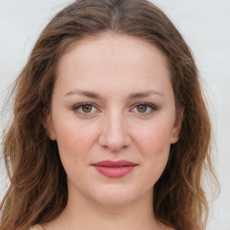 Joyful white young-adult female with long  brown hair and green eyes