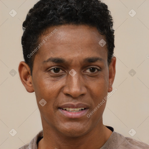 Joyful black adult male with short  black hair and brown eyes