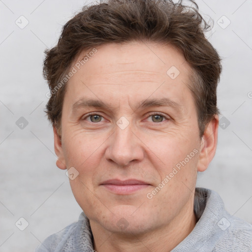 Joyful white adult male with short  brown hair and grey eyes