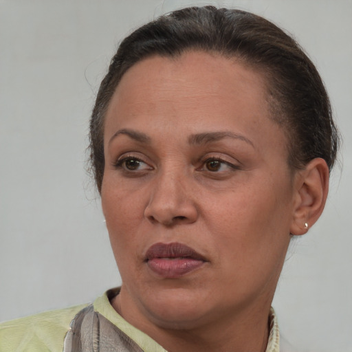 Joyful latino adult female with short  brown hair and brown eyes