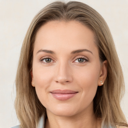 Joyful white young-adult female with long  brown hair and green eyes