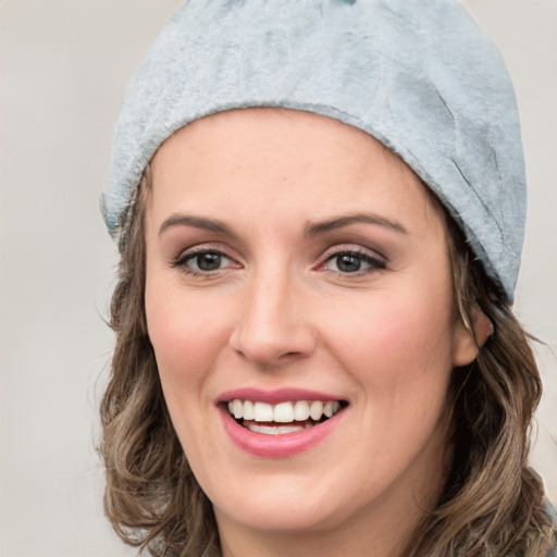 Joyful white young-adult female with long  brown hair and blue eyes