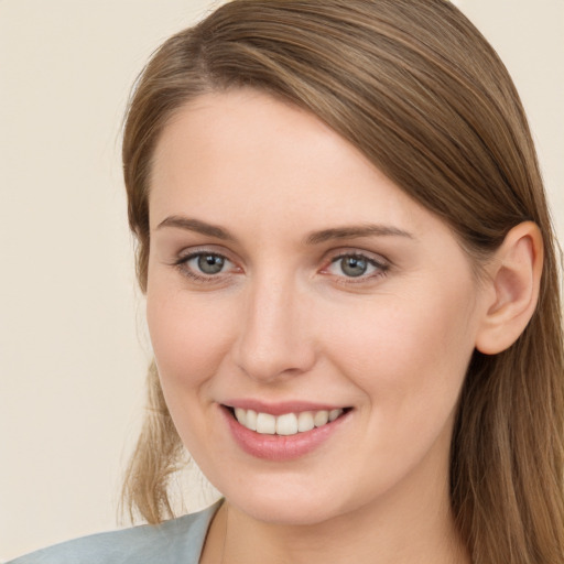 Joyful white young-adult female with long  brown hair and grey eyes