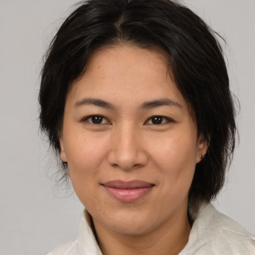 Joyful white adult female with medium  brown hair and brown eyes