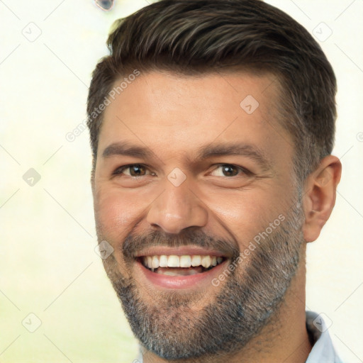 Joyful white adult male with short  brown hair and brown eyes