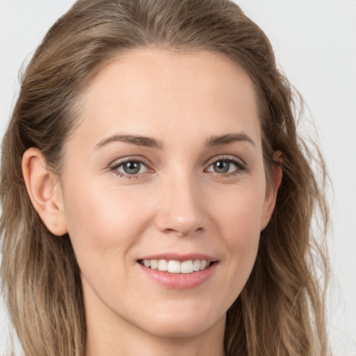 Joyful white young-adult female with long  brown hair and grey eyes