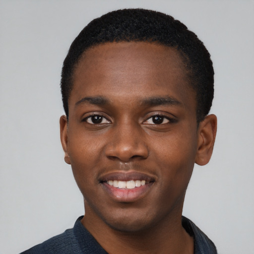 Joyful black young-adult male with short  black hair and brown eyes