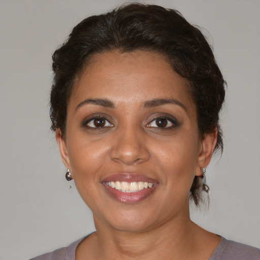 Joyful white adult female with medium  brown hair and brown eyes