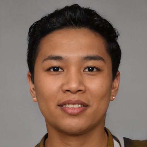 Joyful latino young-adult male with short  black hair and brown eyes