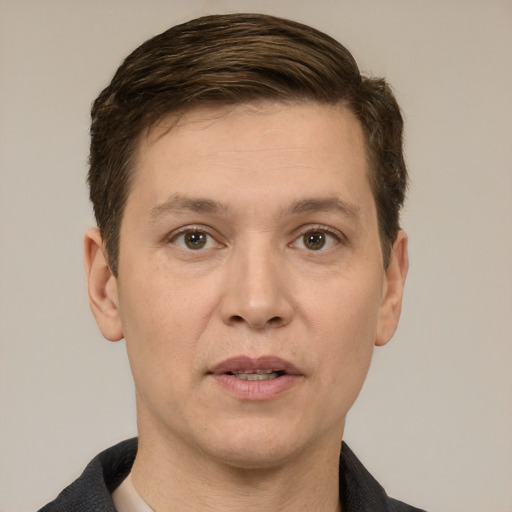 Joyful white adult male with short  brown hair and brown eyes