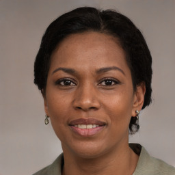 Joyful black young-adult female with medium  brown hair and brown eyes